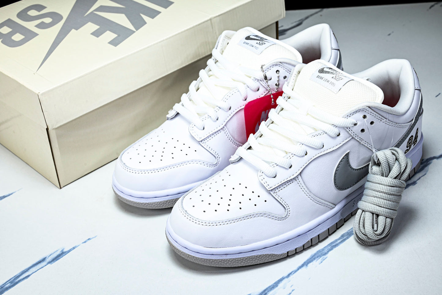 SB Dnk Low x Supreme 94 White Metallic Silver